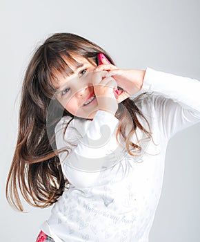 Little caucasian girl with cell phone