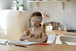 Little Caucasian girl child drawing in album