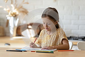 Little Caucasian girl child drawing at home