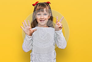 Little caucasian girl kid wearing casual clothes showing and pointing up with fingers number seven while smiling confident and
