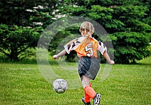 Little Caucasian Girl Playing Soccer