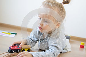 Little Caucasian Girl Playing with Wooden Railway at Home Early Education Games