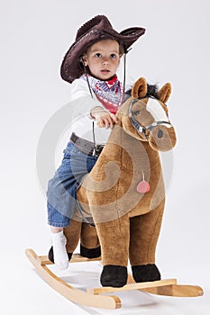 Little Caucasian Girl Posing in Cowgirl Clothing with Toy Horse