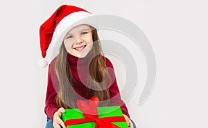 Little caucasian girl smile and holding green gift box on white background.child holding gift box in Christmas and New year