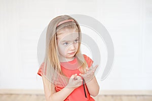 Little caucasian girl thoughtful counting her fingers indoors.