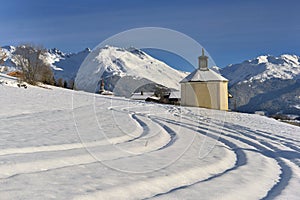 Little chapel in a beautiful snowy mountain landscape