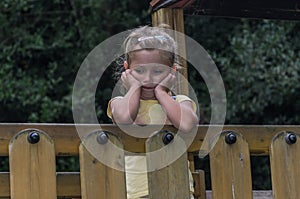 Little charming baby girl standing sad on the playground