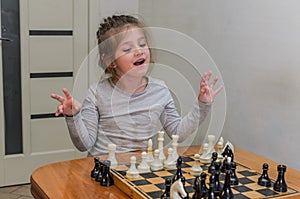 Little charming girl child playing chess