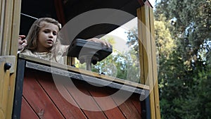 Little charming happy baby girl in the playground