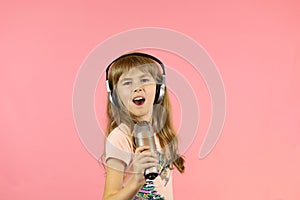 little cheerful girl sings into the microphone.