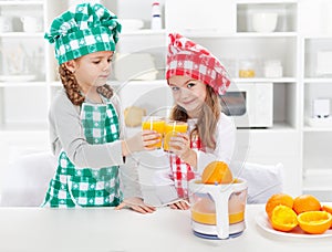 Little chefs making fresh orange juice