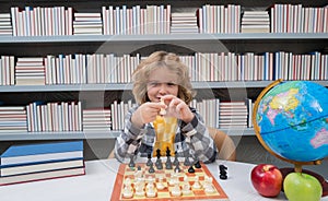 Little chess player. Kid playing chess. Clever child thinking about chess. Kids early development.