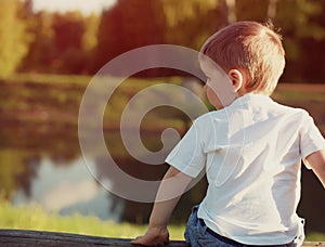 Little child from the back pensive looking away