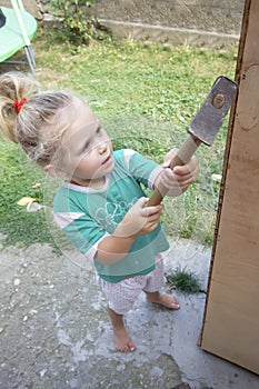 Little child and big hammer photo