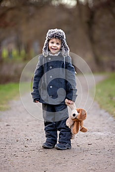 Little child, blond boy with pet dog, carying home on his back, kid, having paper house