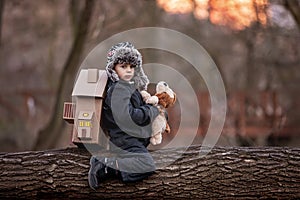 Little child, blond boy with pet dog, carying home on his back, kid, having paper house