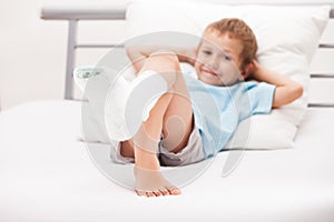 Little child boy with plaster bandage on leg heel fracture or br