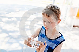 Little child boy playing with fidget spinner