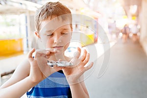 Little child boy playing with fidget spinner