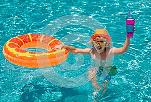 Little child boy in swimming pool with inflatable toy ring. Kids swim on summer vacation. Swim for child on float. Beach