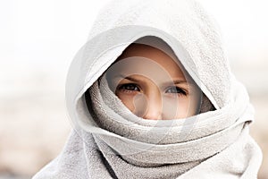Little child boy wearing arabian burka style clothing