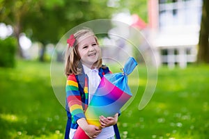 Little child with candy cone on first school day