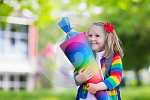 Little child with candy cone on first school day