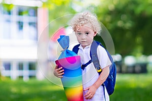 Little child with candy cone on first school day