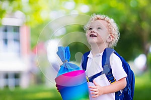 Little child with candy cone on first school day