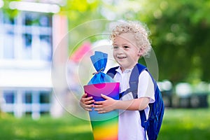 Little child with candy cone on first school day