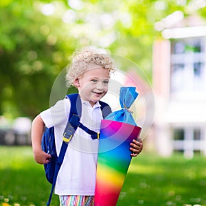 Little child with candy cone on first school day