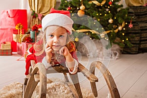 Little child in christmas hat dreaming about christmas miracle.