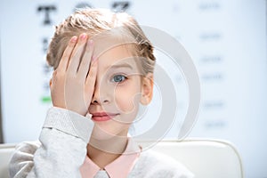 little child closing eye with eye