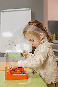 Little Child Concentrated on Bead Sorting Activity