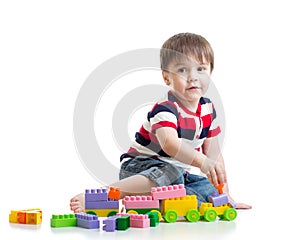 Little child with construction set over white background