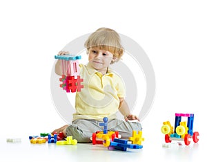 Little child with construction set over white background