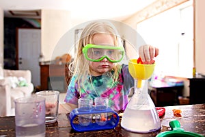 Little Child Doing a Science Experiement with Toy Scientist Kit