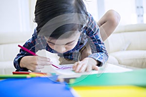 Little child drawing with color pencils