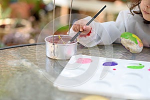 Little Child Drawing On Stone Outdoors In Summer Sunny Day.