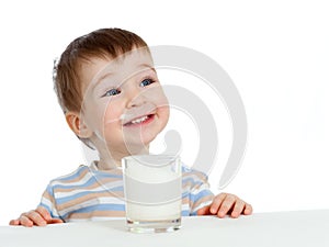 Little child drinking yogurt or kefir over white photo
