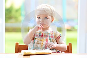 Little child eating bread with butter