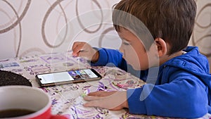 Little child is engaged with a mobile device