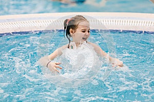 Little child enjoying her time in a hot tub.