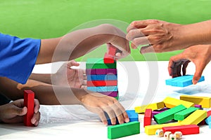 Little child and family playing wood colors block game in activity learning develop IQ of kids, wooden block toy for fun education