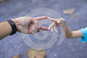 Little child and father bumping fists, man and child giving knuckle bump