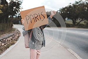 Little child girl 3-4 year old hold handwritten sign paper board travel.