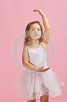 Little child girl dreams of becoming a ballerina.