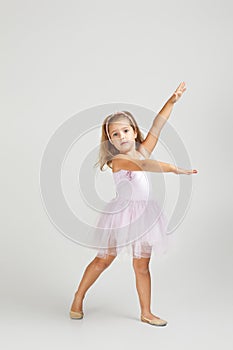 Little child girl dreams of becoming a ballerina.