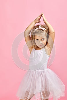 Little child girl dreams of becoming a ballerina.
