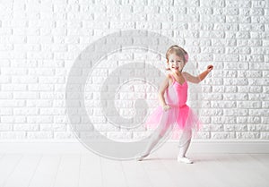 Little child girl dreams of becoming ballerina